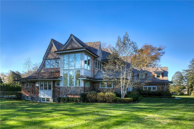 rear view of house featuring a lawn