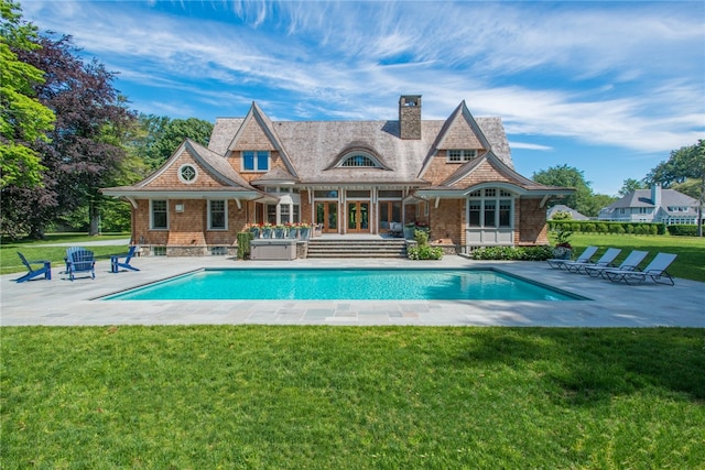 back of property featuring a yard and a patio