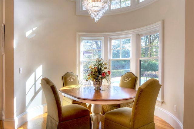 dining space featuring an inviting chandelier and light wood-type flooring