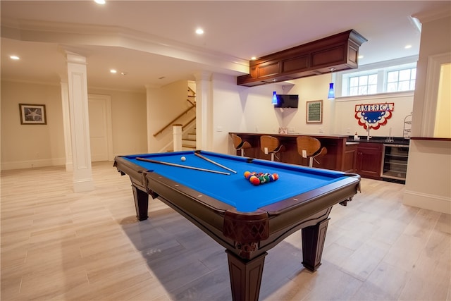 recreation room featuring pool table, light hardwood / wood-style floors, crown molding, wine cooler, and bar