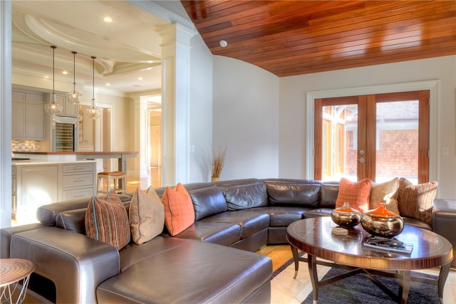 living room with ornate columns, light hardwood / wood-style flooring, french doors, and wooden ceiling