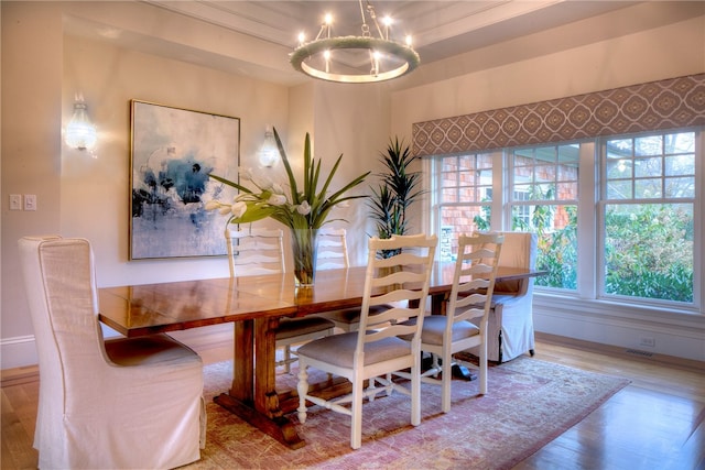 dining area featuring hardwood / wood-style floors and a notable chandelier