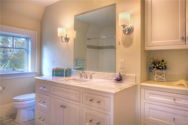 bathroom with walk in shower, vanity, lofted ceiling, and toilet