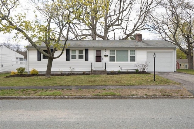 single story home featuring a garage and a front lawn