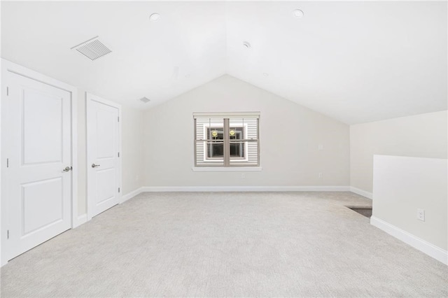 additional living space with lofted ceiling and light colored carpet