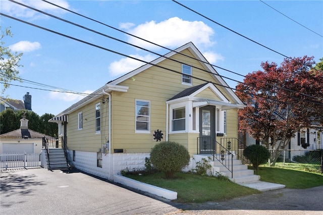 bungalow-style home with a front lawn