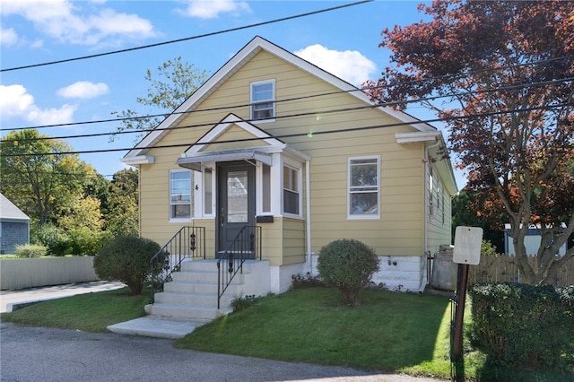 bungalow-style house featuring a front yard