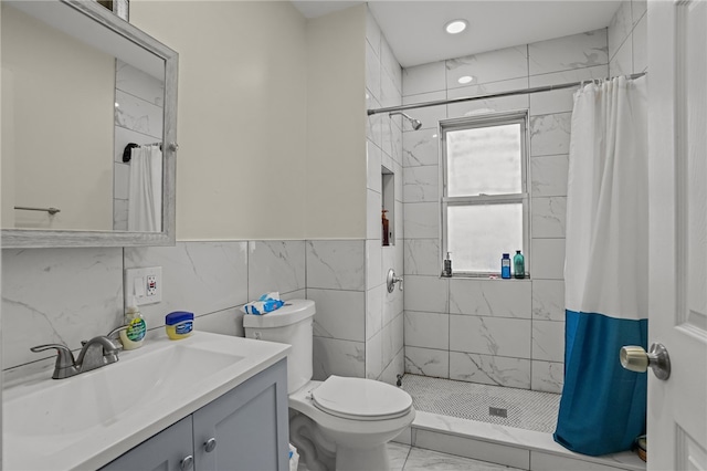 bathroom featuring a shower with curtain, vanity, tile walls, and toilet