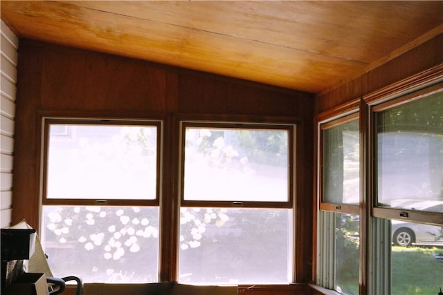 unfurnished sunroom featuring lofted ceiling and wood ceiling