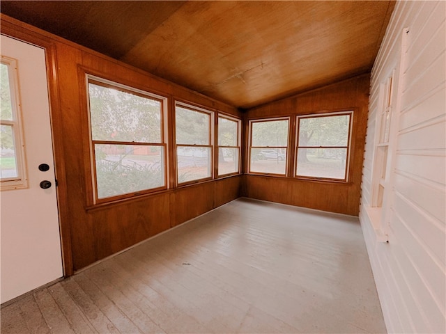 unfurnished sunroom with plenty of natural light, lofted ceiling, and wood ceiling