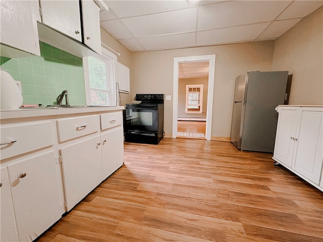 kitchen with stainless steel fridge, black / electric stove, light hardwood / wood-style flooring, and white cabinetry