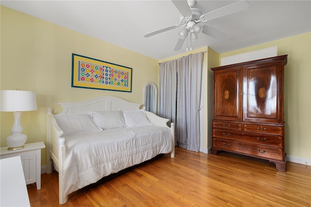 bedroom with ceiling fan and light hardwood / wood-style floors