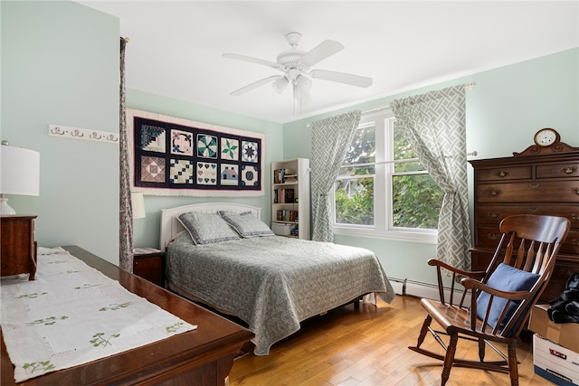 bedroom with baseboard heating, ceiling fan, and light hardwood / wood-style flooring