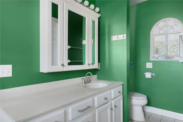 bathroom with tile patterned floors, vanity, and toilet