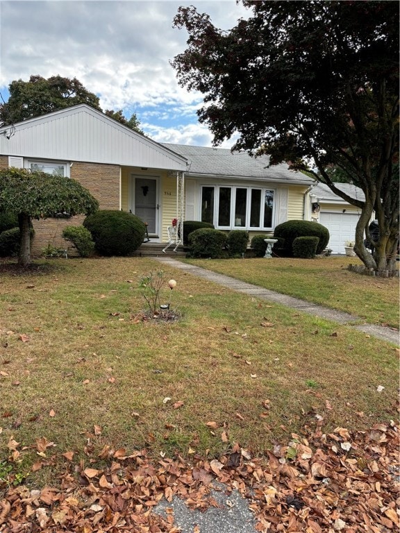 ranch-style home with a garage and a front lawn