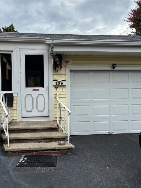 doorway to property with a garage