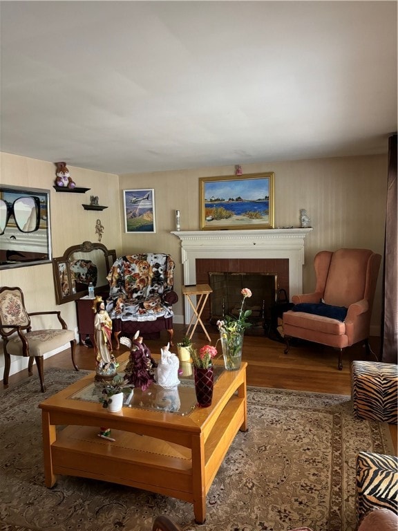 living room with hardwood / wood-style floors and a tile fireplace