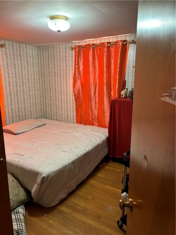 bedroom with wood-type flooring