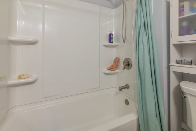 bathroom with toilet and shower / bathtub combination with curtain