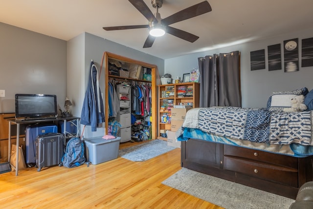 bedroom featuring ceiling fan, a closet, and hardwood / wood-style floors