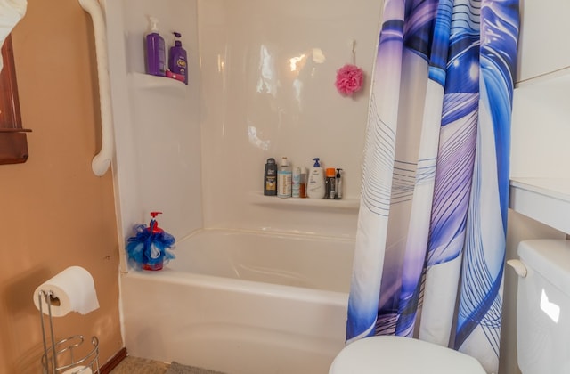 bathroom with shower / bathtub combination with curtain and toilet