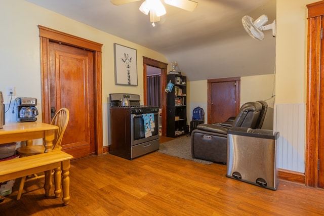 interior space with ceiling fan, lofted ceiling, and hardwood / wood-style floors