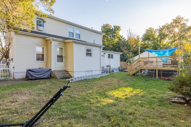 back of house featuring a yard and a deck