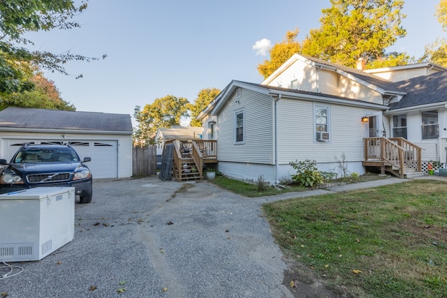 view of side of home with a garage and a lawn