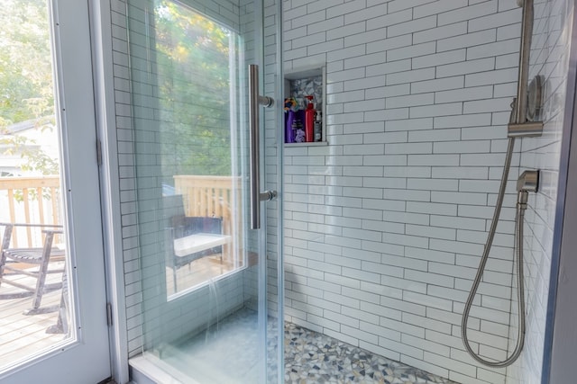 bathroom featuring a shower with shower door