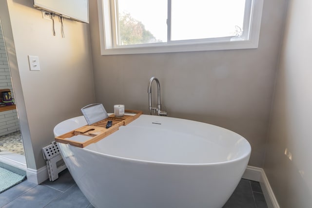 bathroom featuring tile patterned flooring and a tub