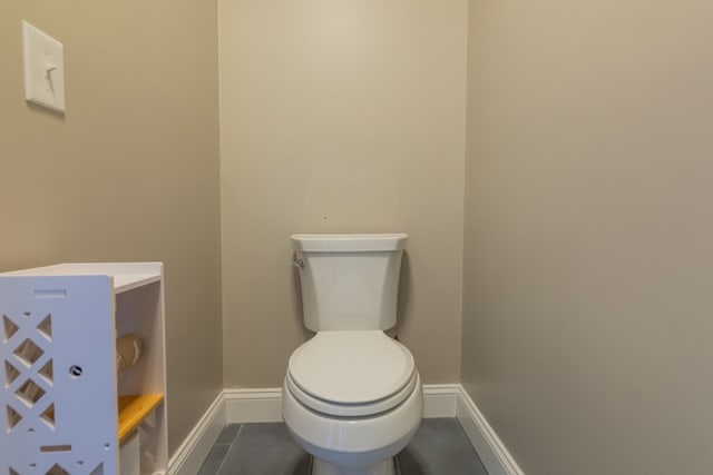 bathroom with tile patterned flooring and toilet