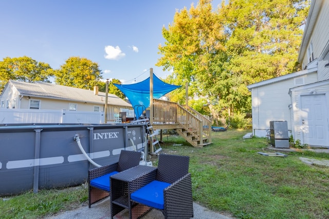 view of yard with a swimming pool side deck