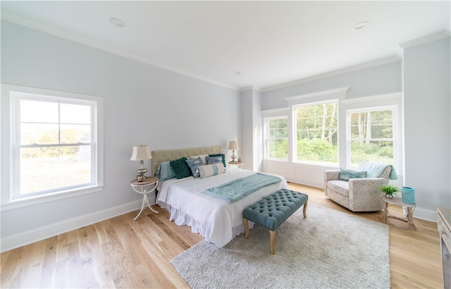 bedroom featuring ornamental molding and light wood-type flooring