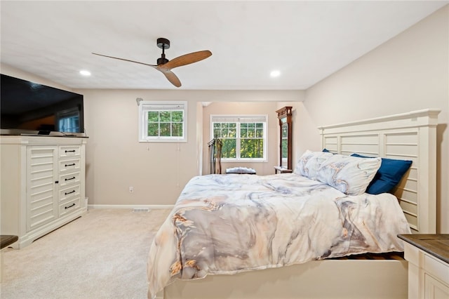 bedroom with light carpet and ceiling fan