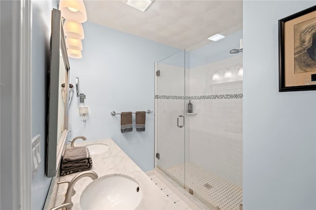 bathroom with a shower with door and vanity