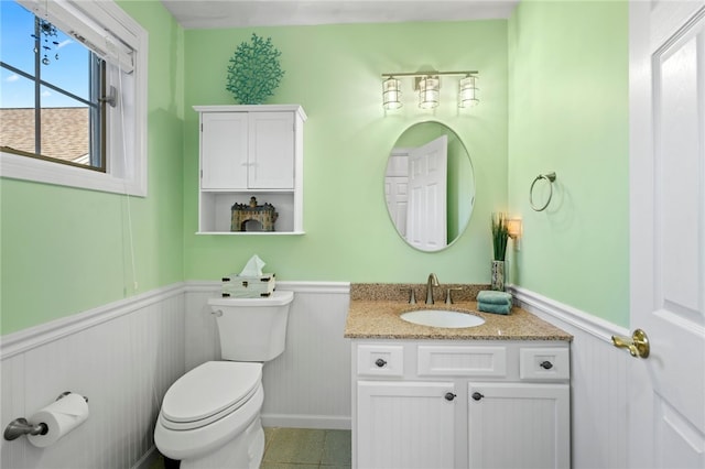 bathroom featuring vanity, tile patterned flooring, and toilet