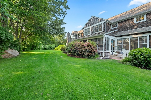 view of yard featuring a sunroom