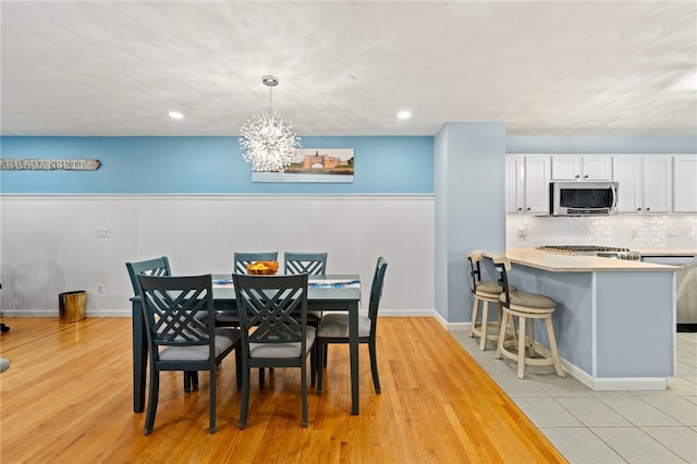 dining space featuring a chandelier and light hardwood / wood-style floors