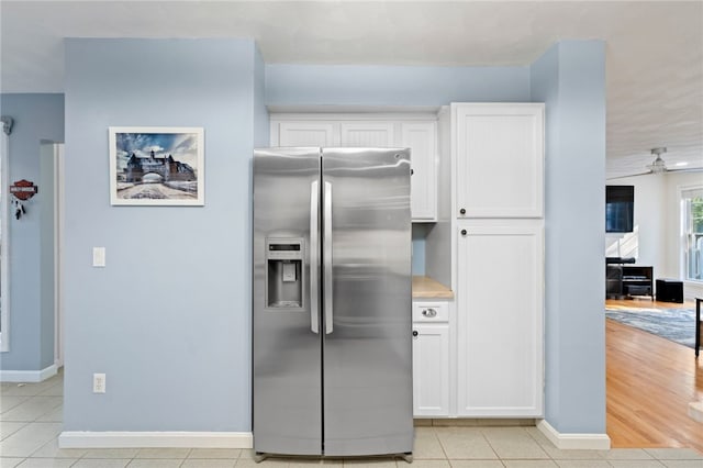 kitchen featuring ceiling fan, white cabinets, light wood-type flooring, and stainless steel fridge with ice dispenser