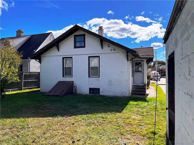 rear view of property with a lawn