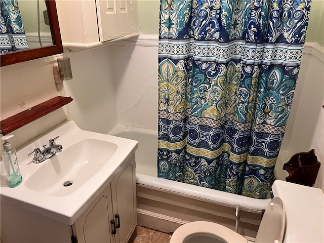 full bathroom featuring vanity, shower / bath combo with shower curtain, and toilet