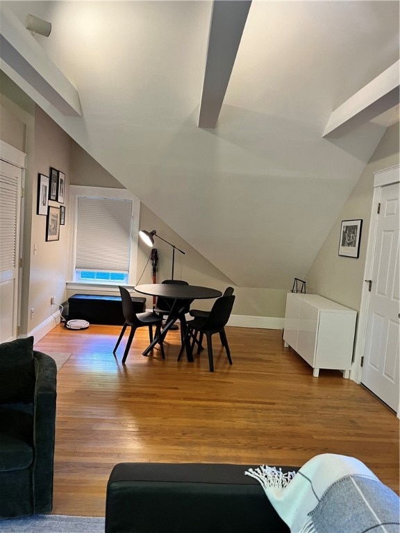 dining room featuring lofted ceiling and wood-type flooring