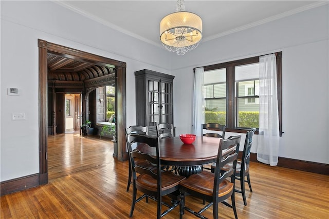 68 Kay St, Newport, RI 02840 - dining area featuring baseboards, ornamental molding, wood finished floors, and a notable chandelier