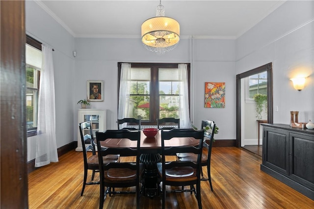 68 Kay St, Newport, RI 02840 - dining room with dark wood-type flooring, ornamental molding, baseboards, and a notable chandelier