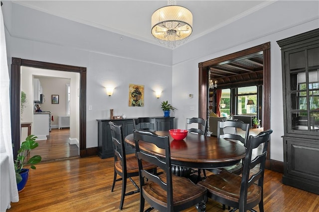 68 Kay St, Newport, RI 02840 - dining space featuring radiator heating unit, baseboards, dark wood-style floors, and a chandelier