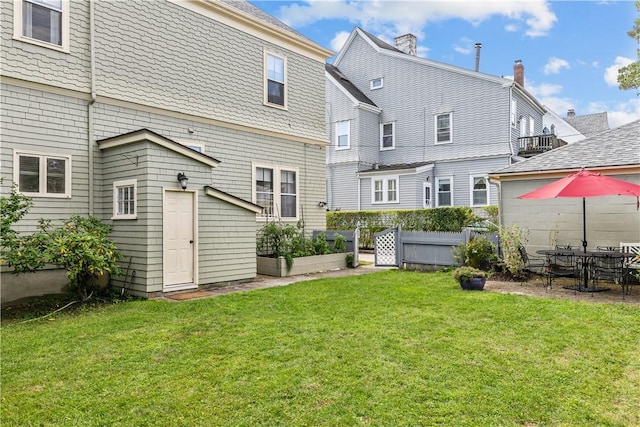 68 Kay St, Newport, RI 02840 - back of house with fence, a yard, and a vegetable garden