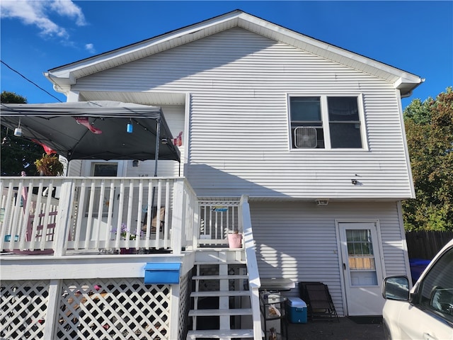 rear view of house with a wooden deck