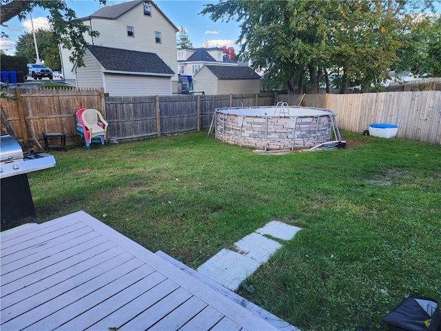 view of yard with a fenced in pool