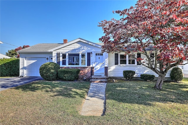 view of front of house with a front lawn and a garage