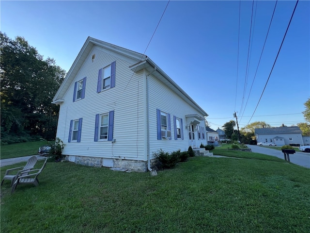 view of side of property with cooling unit and a yard